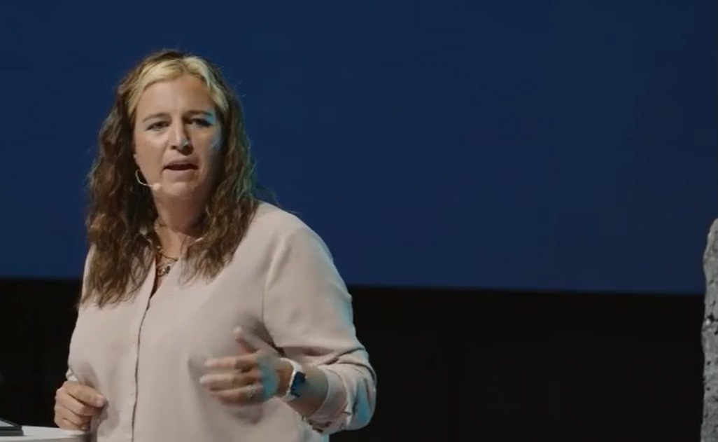 Heather speaking on stage